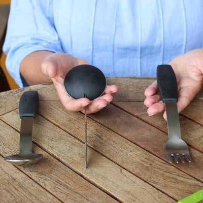Woman holding adapted disability cutlery
