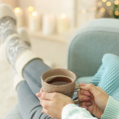 Person relaxing with cup of tea