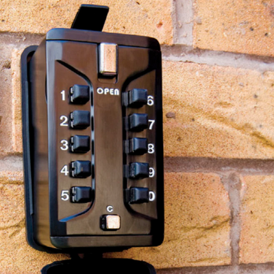 A picture of a key safe attached to a wall
