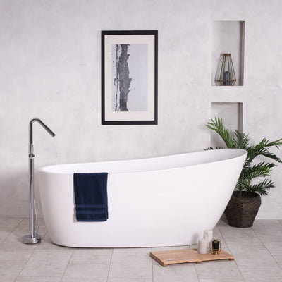 Bath tub in a bathroom with a towel and wooden bath mat