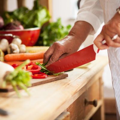 Chef chopping vegetables on chopping board