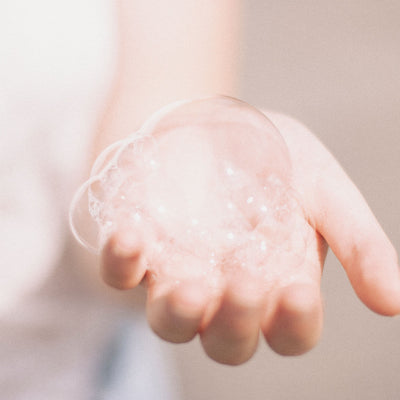Womans hand holding bubbles