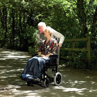Wheelchair user wearing a waterproof cosy