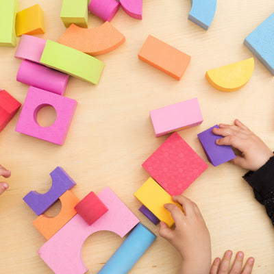 Children play with foam building blocks and shapes