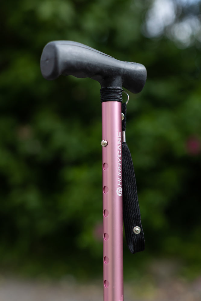 A close up of the height adjustable section on a pink Hurrycane Freestanding Walking Stick
