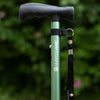 A close up of a green Hurrycane Freestanding Walking Stick