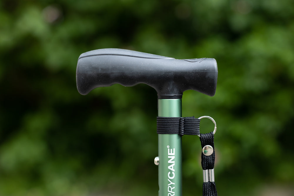 A close up of the handle on a green Hurrycane Freestanding Walking Stick