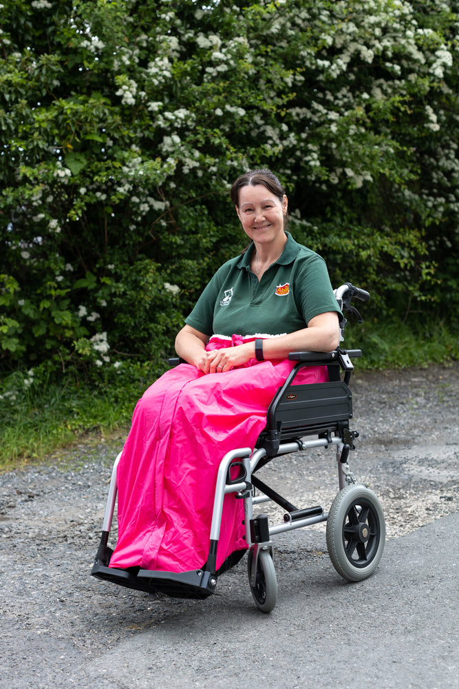 Carol from ability superstore with a pink wheelchair apron