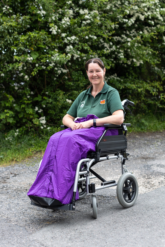 Carol from ability superstore with a purple wheelchair apron