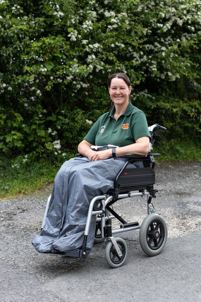Carol from ability superstore with a grey wheelchair apron