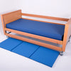 The Bed Fall Safety Mat, next to a bed.