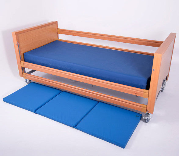 The Bed Fall Safety Mat, next to a bed.