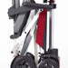 A side view of the red Manual Fold+ Scooter fullly folded up