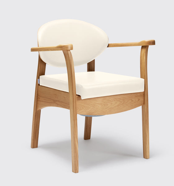 the image shows the off white oak commode chair