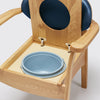 the image shows a close up of the pan on the blue oak commode chair