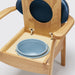 the image shows a close up of the pan on the blue oak commode chair
