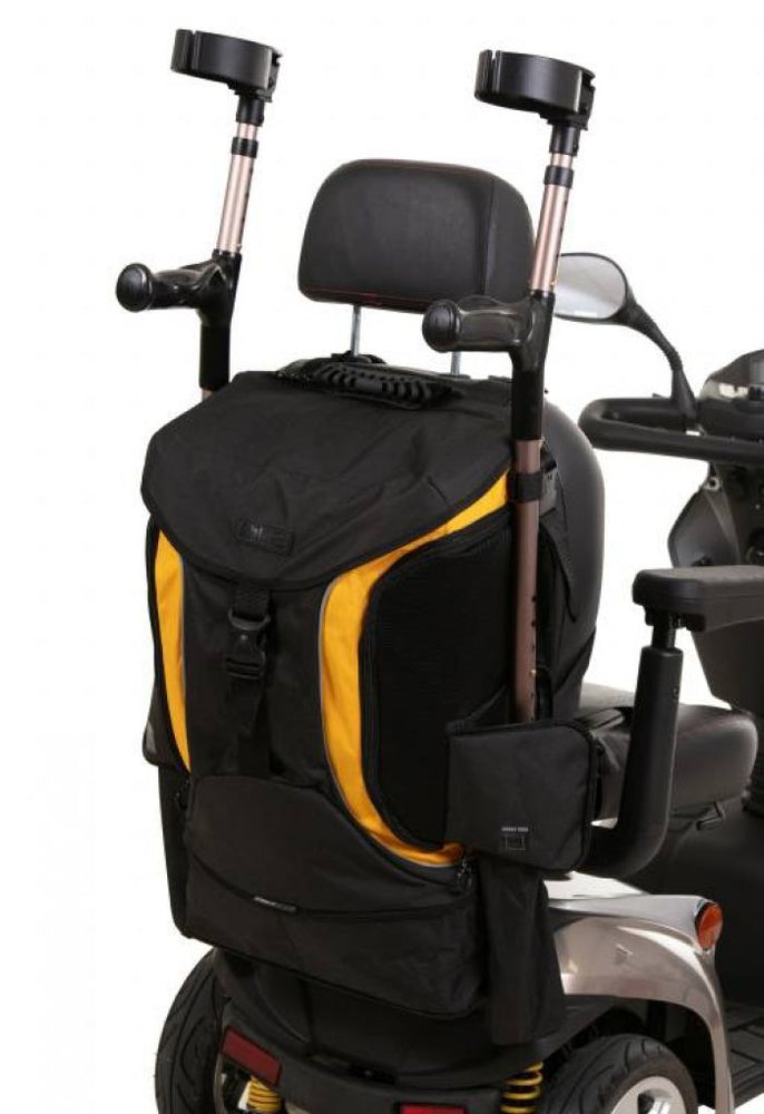 Image of the yellow and black torba go back of the back of a mobility scooter, holding a pair of cruches