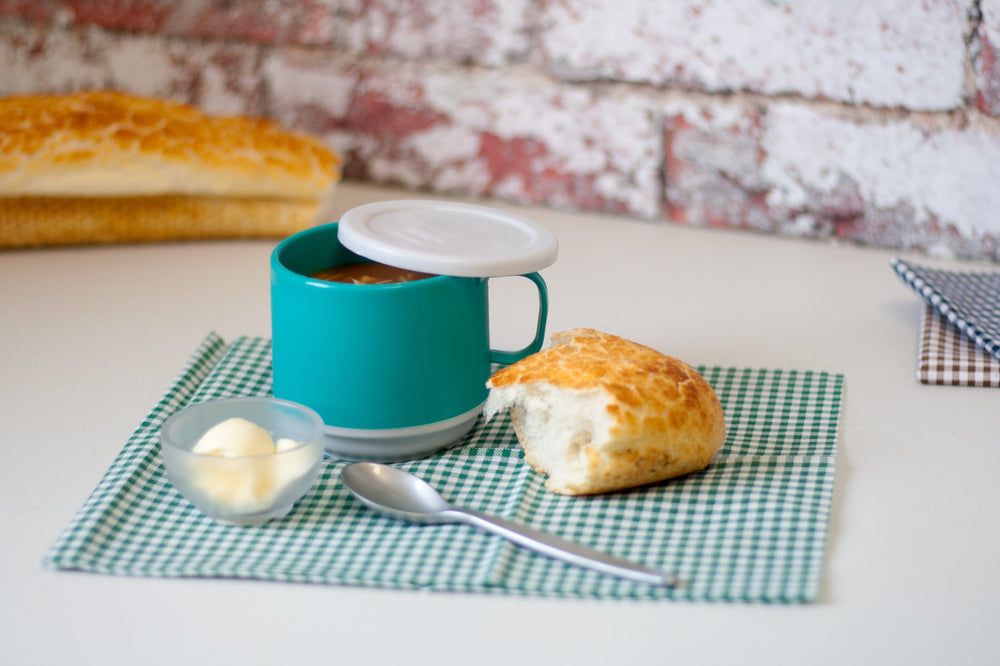 Turquoise Mug with lid on table