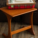 The Royal Stewart Red Tartan Lap Tray on a wooden coffee table in a living room