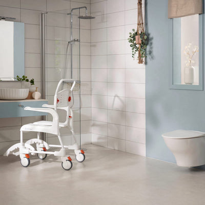 A white bath chair sitting next to an accessible shower in a light coloured bathroom.