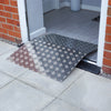 An aluminium threshold bridging ramp over a threshold