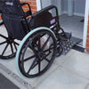 A Wheelchair going over an Aluminium Threshold Bridging Ramp