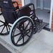 A Wheelchair going over an Aluminium Threshold Bridging Ramp