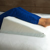 a woman using the bed wedge pillow to elevate her legs
