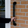 Prima outdoor grab rail fixed to an outer brick wall and a hand grasping the rail