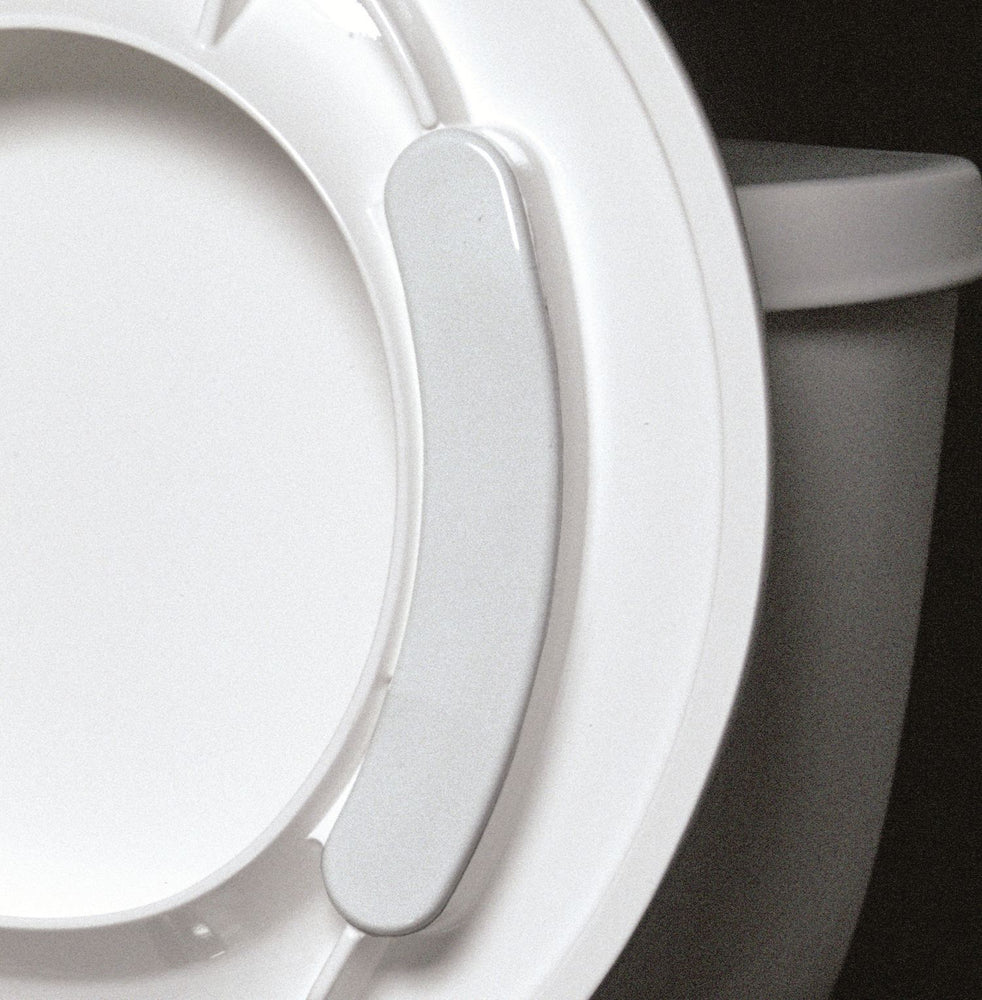the image shows a close up of how the big john toilet seat attaches to a standard toilet seat