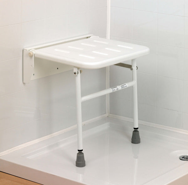 the Solo wall mounted shower seat fitted to a white tiled wall in a shower tray