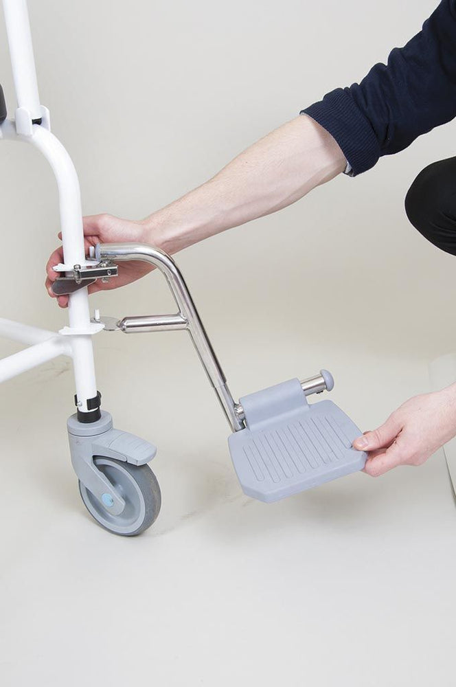 the image shows a close up of the footrest on a bariatric mobile commode