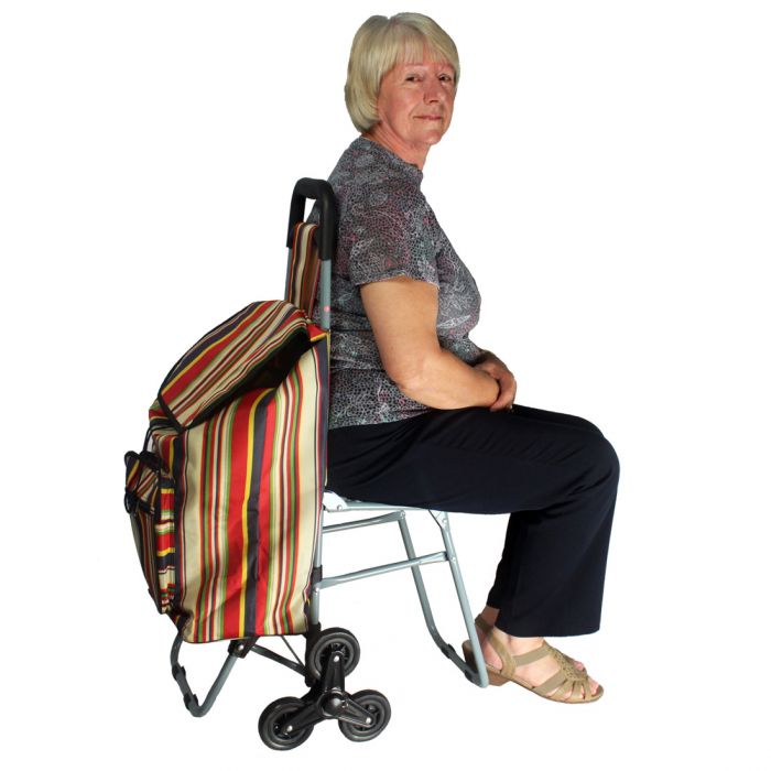 A women sitting on the seat of the Lifemax 'Take a Seat' Shopping and Leisure Trolley Stair Climber
