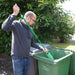 shows a man using the wheelie bin loofah