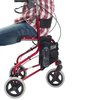 shows someone sitting on the red tri-walker walking aid with seat