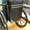 shows the flexi mobility bag large attached to the back of a self propelled wheelchair