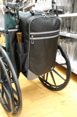 shows the flexi mobility bag large attached to the back of a self propelled wheelchair