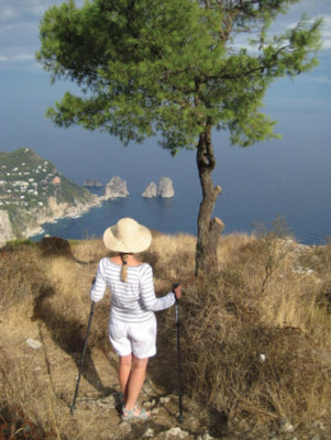 shows a woman using two folding trekking poles