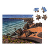 shows a wild coast jigsaw puzzle with four pieces yet to be added