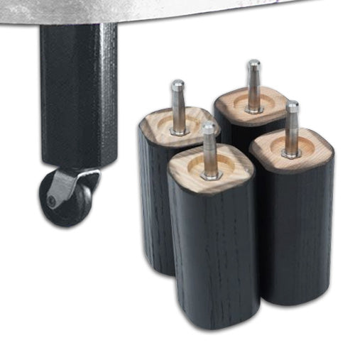 the image shows four wooden bed raisers next to the wheel of a chair or possibly a table