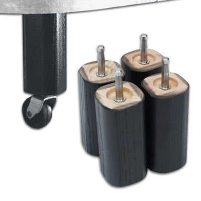 the image shows four wooden bed raisers next to the wheel of a chair or possibly a table