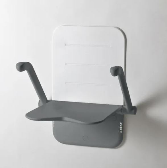 A grey etac relax shower seat with the arms in an upright position 