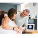 a couple looking at the reminder clock in their home