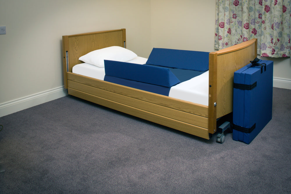 A bed with a fall mat on it