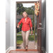 shows a woman moving through a front-door with a step, using the Flip-A-Grip Support Handle