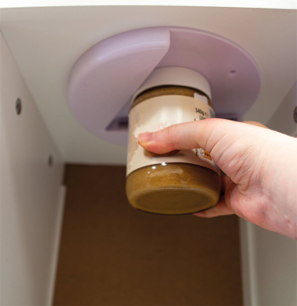 Jar being opened using under cabinet jar opener