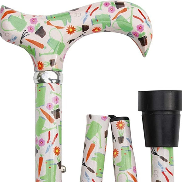 the image shows the classic canes folding fashion derby cane with the gardening pattern; watering cans, carrots, flowers, pruners, plant pots and wellington boots