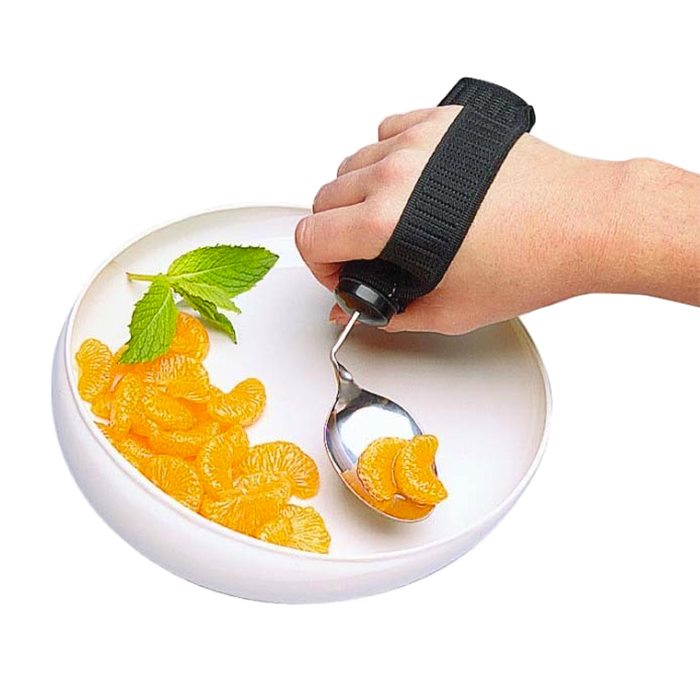 shows a hand with the Goodie strap elasticated cutlery strap with a spoon attached