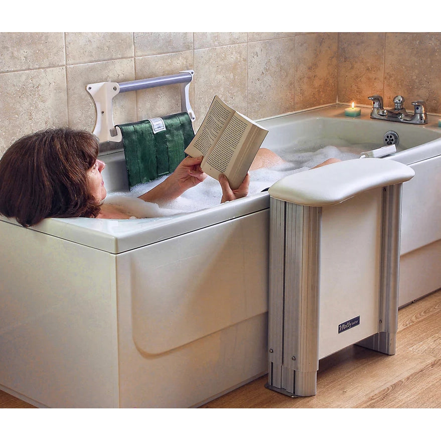 Woman in bath with the Molly Bather Belt Bath Lift next to the tub