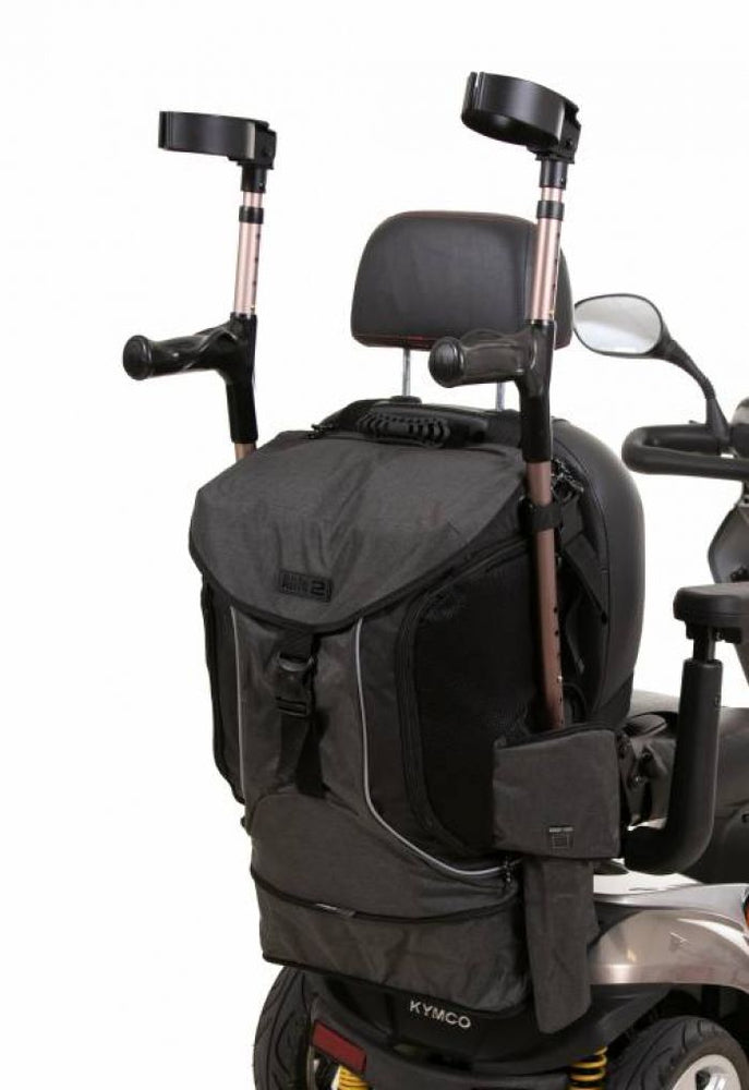 Image of the grey and black torba go back of the back of a mobility scooter, holding a pair of cruches